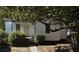 Cozy single-story home with white siding, complemented by lush landscaping and mature trees at 2326 Kent Ave, North Charleston, SC 29405