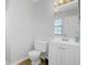 This full bathroom is equipped with tile flooring, a white sink and toilet, and a lighted mirror at 2362 Parsonage Rd # 2G, Charleston, SC 29414