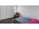 Bedroom featuring hardwood floors, a closet, and a relaxing brown arm chair to add a warm and inviting feel at 2362 Parsonage Rd # 2G, Charleston, SC 29414