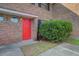 View of the brick exterior and bright red front door at 2362 Parsonage Rd # 2G, Charleston, SC 29414