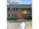 Brick townhouse featuring red doors and manicured landscaping at 2362 Parsonage Rd # 2G, Charleston, SC 29414
