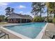 Community swimming pool with a shallow end, surrounded by lounge chairs, offering a relaxing recreational space at 2362 Parsonage Rd # 2G, Charleston, SC 29414