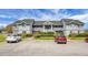 Condo building with well manicured landscaping, lawn, and parking area for residents and guests at 2608 Hidden Cove Dr, Moncks Corner, SC 29461