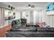 Open concept living room with hardwood floors, bar seating, and view of screen door at 2608 Hidden Cove Dr, Moncks Corner, SC 29461