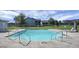 Community pool with crystal blue water and stainless steel hand rails and gated fence at 2608 Hidden Cove Dr, Moncks Corner, SC 29461