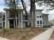 Two-story condos featuring charming balconies and a sidewalk, set amidst mature trees and landscaping at 276 Alexandra Dr # 6, Mount Pleasant, SC 29464