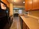 Efficient kitchen with warm wood cabinetry, essential appliances, and a convenient breakfast bar at 276 Alexandra Dr # 6, Mount Pleasant, SC 29464