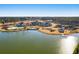 Stunning aerial view of a lakeside community with a pool, tennis courts, and beautifully landscaped grounds at 314 Quiet Cove Trl, Summerville, SC 29486