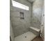 Elegant bathroom shower with marbled tiling and a built-in bench at 314 Quiet Cove Trl, Summerville, SC 29486