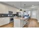 Modern kitchen with stainless steel appliances, granite countertops, and ample seating at 326 Ripple Park Dr, Summerville, SC 29486
