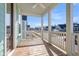 Inviting porch with wooden floors, white columns, and ceiling fan, offering relaxing outdoor space at 326 Ripple Park Dr, Summerville, SC 29486