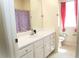 Bathroom showcasing a sink, mirror, and toilet, enhanced with a shower curtain and accentuating red curtains at 3406 Mariners Way, Moncks Corner, SC 29461