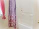 Bright bathroom featuring a bathtub with a charming butterfly-themed shower curtain and white tiled walls at 3406 Mariners Way, Moncks Corner, SC 29461