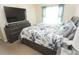 Comfortable bedroom featuring a queen-size bed with stylish bedding, accompanied by a dresser and TV at 3406 Mariners Way, Moncks Corner, SC 29461