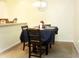 Dining area featuring a square table covered by a dark tablecloth and surrounded by carpeted floors at 3406 Mariners Way, Moncks Corner, SC 29461