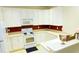 Bright kitchen equipped with white cabinets, countertops, and appliances, complete with a breakfast bar area at 3406 Mariners Way, Moncks Corner, SC 29461