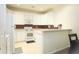 Bright kitchen featuring white cabinets, countertops, and appliances, complete with a breakfast bar at 3406 Mariners Way, Moncks Corner, SC 29461