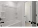 Bright white bathroom showcasing a bathtub with shower and an open door to the vanity at 351 Blue Oak Dr, Moncks Corner, SC 29461