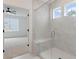 Luxurious bathroom with walk-in glass shower and a glimpse of a bedroom with ample natural light at 351 Blue Oak Dr, Moncks Corner, SC 29461