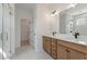 Elegant bathroom featuring a large mirror, double vanity, and marble shower with glass door at 351 Blue Oak Dr, Moncks Corner, SC 29461