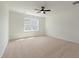 Bright, open bedroom featuring plush carpeting, a ceiling fan, and a window with natural light at 351 Blue Oak Dr, Moncks Corner, SC 29461