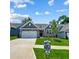 Charming single-story home with a well-maintained lawn and a two-car garage at 351 Blue Oak Dr, Moncks Corner, SC 29461