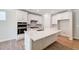 Modern kitchen with white cabinets, center island, and stainless appliances at 351 Blue Oak Dr, Moncks Corner, SC 29461