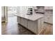 Island kitchen with white cabinets and hardwood floors at 351 Blue Oak Dr, Moncks Corner, SC 29461