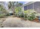Spacious backyard with stone patio, screen porch, and mature landscaping at 3518 Gatetree Rd, Johns Island, SC 29455