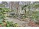 Expansive backyard with stone patio, lovely water feature, and lush greenery at 3518 Gatetree Rd, Johns Island, SC 29455
