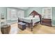 Spacious bedroom featuring a decorative wood frame bed, hardwood floors, and bright natural light at 3518 Gatetree Rd, Johns Island, SC 29455