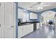 Bright kitchen features white cabinetry, black countertops and appliances, and stylish blue patterned flooring at 3518 Gatetree Rd, Johns Island, SC 29455