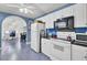 Cozy kitchen features white appliances, cabinetry, and an arched entrance leading to an adjoining room at 3518 Gatetree Rd, Johns Island, SC 29455
