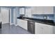 Well-lit kitchen with white cabinets, black countertops, and matching appliances at 3518 Gatetree Rd, Johns Island, SC 29455