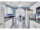Bright kitchen showcasing white cabinetry, black counters and appliances, and archway to dining or office space at 3518 Gatetree Rd, Johns Island, SC 29455