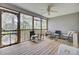 Relaxing screened porch with wooden floors, offering views of lush greenery and comfortable seating at 3518 Gatetree Rd, Johns Island, SC 29455