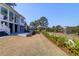 The expansive backyard offers a view of a picturesque pond and showcases the home's architecture with an outdoor space at 4176 Victory Pointe Dr, Mount Pleasant, SC 29466