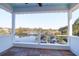 Covered porch with plank flooring, white railing, and serene water views at 4176 Victory Pointe Dr, Mount Pleasant, SC 29466