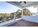 Covered porch with plank flooring, white railing, and a view of the waterfront at 4176 Victory Pointe Dr, Mount Pleasant, SC 29466
