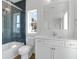 Charming bathroom with blue tiled shower, white vanity, and natural light from a window at 4176 Victory Pointe Dr, Mount Pleasant, SC 29466