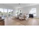 Bright bedroom with light hardwood flooring, and balcony access to views of mature trees at 4176 Victory Pointe Dr, Mount Pleasant, SC 29466