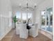 Charming dining room featuring a modern chandelier and serene lake views visible through large windows at 4176 Victory Pointe Dr, Mount Pleasant, SC 29466