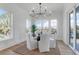 Bright dining area offers elegant seating and a stunning view of the outdoor landscape through expansive windows at 4176 Victory Pointe Dr, Mount Pleasant, SC 29466