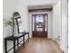 Welcoming foyer with hardwood floors, shiplap walls, console table and a view of the entrance at 4176 Victory Pointe Dr, Mount Pleasant, SC 29466