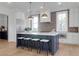 Well-appointed kitchen with stainless steel appliances, brick accent wall, and center island with seating at 4176 Victory Pointe Dr, Mount Pleasant, SC 29466