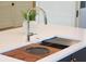 Close up of kitchen island with a stainless steel faucet and integrated wood cutting board at 4176 Victory Pointe Dr, Mount Pleasant, SC 29466