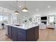 Spacious open-concept kitchen with island, seamlessly flowing into the adjacent living room, perfect for entertaining at 4176 Victory Pointe Dr, Mount Pleasant, SC 29466