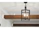 Stylish iron pendant light with exposed beams and shiplap walls adds a touch of elegance at 4176 Victory Pointe Dr, Mount Pleasant, SC 29466