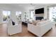 Bright living room with white armchairs, comfortable seating, fireplace and natural light from windows at 4176 Victory Pointe Dr, Mount Pleasant, SC 29466