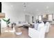 Bright living room with white shiplap walls and light hardwood floors open to gourmet kitchen at 4176 Victory Pointe Dr, Mount Pleasant, SC 29466